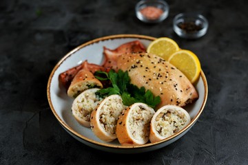 Fresh stuffed squids with rice and mushrooms baked in the oven.