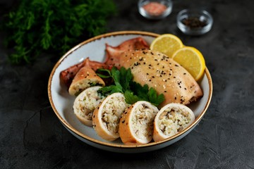 Fresh stuffed squids with rice and mushrooms baked in the oven.