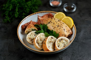 Fresh stuffed squids with rice and mushrooms baked in the oven.