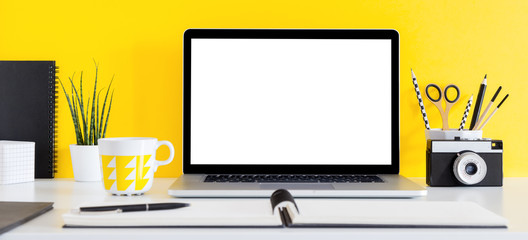 Laptop screen template, supplies and yellow wall. Modern colored mock up.