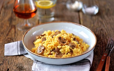 Traditional Italian risotto with  mushrooms, saffron, parmesan cheese, vegetable broth and white wine. Top view. Copy space. 