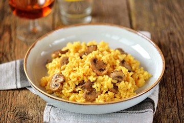 Traditional Italian risotto with  mushrooms, saffron, parmesan cheese, vegetable broth and white wine. Top view. Copy space. 
