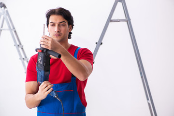 Young handsome contractor working indoors 