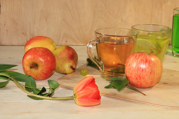 Grape and apple juice, apples and pears on a wooden background, spring tulip. Cool drinks, a mixture of different grape varieties and summer diet