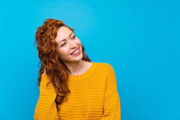 Redhead woman with yellow sweater thinking an idea