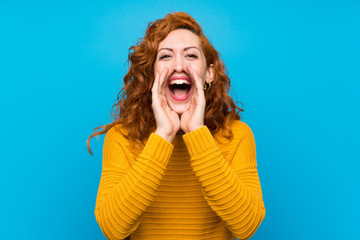 Redhead woman with yellow sweater shouting and announcing something
