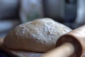 Fresh bread dough and a rolling pin