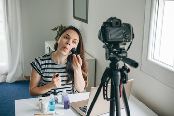 A beauty blogger or video blogger tells and shows subscribers how to do makeup.