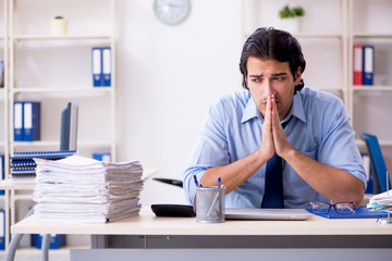 Naklejka premium Young male businessman employee unhappy with excessive work 