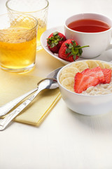 Bowl of breakfast muesli decorated with banana, strawberry slices and chia seed