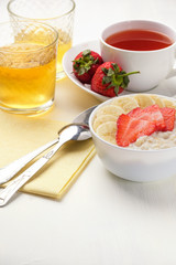 Bowl of breakfast muesli decorated with banana, strawberry slices and chia seed