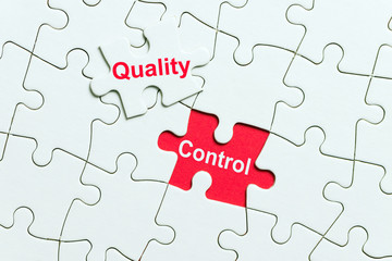 White puzzle with a word quality control