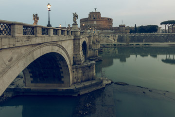 Aurelius bridge over Tiber river in the historic center of Rome with side view of Castel Sant...