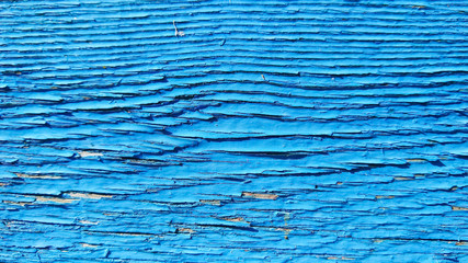 Blue wooden background of cracked surface. Wooden background painted in blue. Abstract rustic pattern