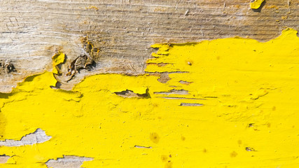 Yellow wooden background of cracked surface. Wooden background painted in yellow. Abstract pattern...