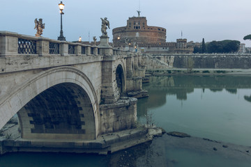 Side view of the Aurelius bridge with historic illumination over the Tiber at dawn. Stone bridge...