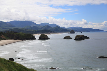 the coast with big rocks in the water 