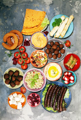 Middle eastern or arabic dishes and assorted meze, concrete rustic background. Falafel. Turkish...