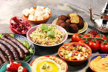 Middle eastern or arabic dishes and assorted meze, concrete rustic background. Falafel. Turkish Dessert Baklava with pistachio. Halal food. Lebanese cuisine