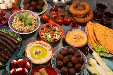 Middle eastern or arabic dishes and assorted meze, concrete rustic background. Falafel. Turkish Dessert Baklava with pistachio. Halal food. Lebanese cuisine