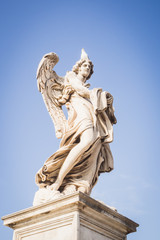 Fototapeta na wymiar Statue of an angel on the blue sky of Rome