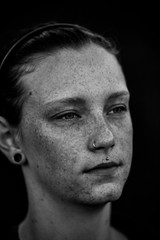 Young attractive red head girl with freckles enjoying relaxation out in the nature