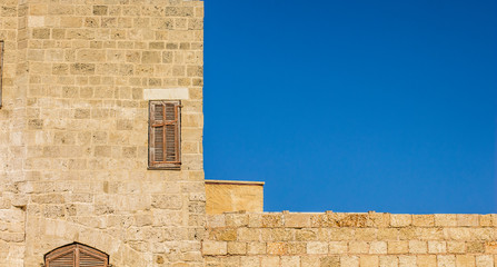 medieval architecture building brick wall corner frame with window wooden closed shutters facade...