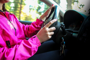 A young woman drives a modern car road that goes through the mountain.Concept.-relaxed drive after...