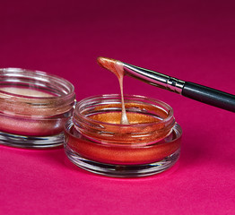 Metallic Illuminator Makeup Dripping from Brush