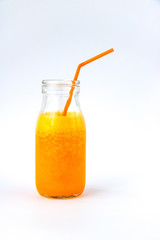 Tangerine smoothie in a glass bottle on a white background.