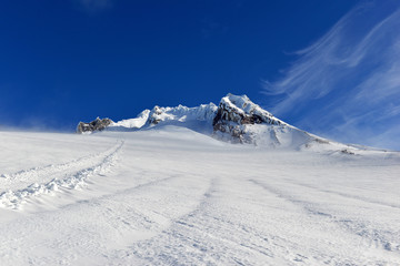 Snow covered terrain on Mount Hood, a volcano in the Cascade Mountains in Oregon popular for hiking, climbing, snowboarding and skiing, despite risks of avalanche, crevasses and weather on the peak.