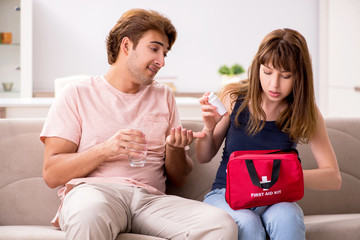 Young family getting treatment with first aid kit