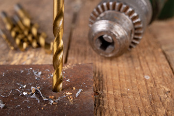 Drilling with a metal drill. Small locksmith work in the home workshop.