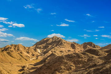 Fototapeta na wymiar dry sand stone mountains in desert dunes scenic landscape environment 