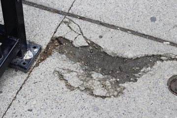 pothole on a sidewalk