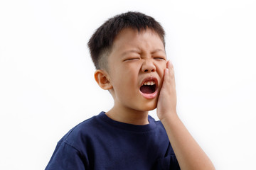 Asian kid suffering from toothache pain, holding his cheek, isolated on white background. Dental Health And Care Concept.