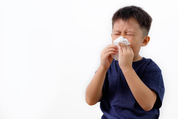 Sick little Asian boy wiping or cleaning nose with tissue isolated white background