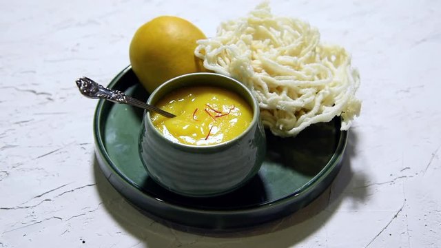 Aam Ras or Alphonso mango pulp with kurdai which is a fried dish made using wheat/gehu. selective focus