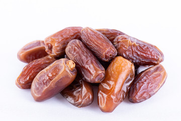 Ramadan food and drinks concept. Close up dates fruit on white background.