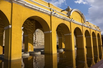 Public Laundry Fountain, Tanque lavadero el Parque la Union, with Spanish Colonial Architecture Yellow Arches in Old City Antigua Guatemala, Unesco World Heritage Site