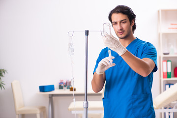 Young male doctor in blood transfusion concept 