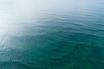 Fototapeta premium Aerial drone view of beautiful sea wave surface in the sunrise