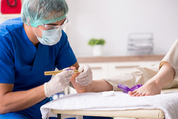 Podiatrist treating feet during procedure