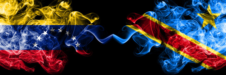 Venezuela vs Democratic Republic of the Congo smoky mystic flags placed side by side. Thick colored silky smoke flags of Venezuela and Democratic Republic of the Congo