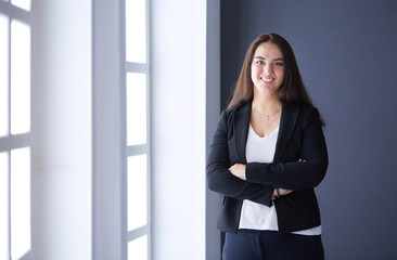 Modern business woman standing in the office .