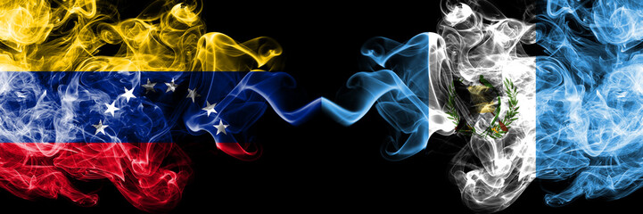 Venezuela vs Guatemala, Guatemalan smoky mystic flags placed side by side. Thick colored silky smoke flags of Venezuela and Guatemala, Guatemalan