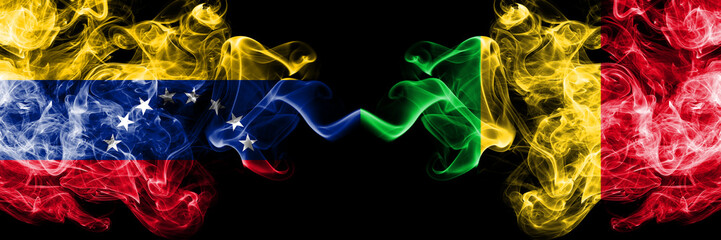 Venezuela vs Mali smoky mystic flags placed side by side. Thick colored silky smoke flags of Venezuela and Mali