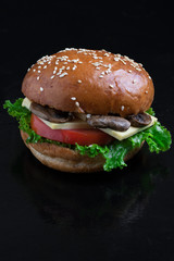 crispy vegetarian burgers with mushrooms and marzipan cheese, tomato and salad leaves,baked bun with sesame 
