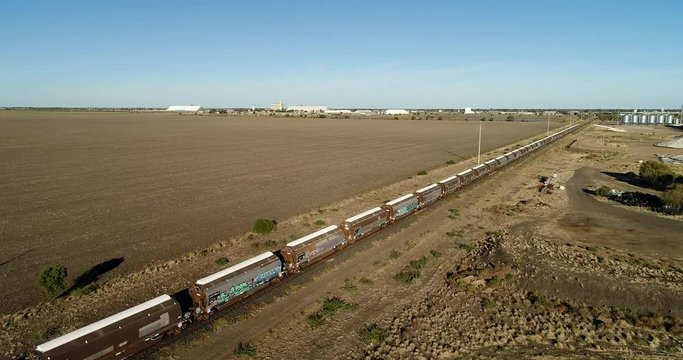 Train of cisterns on railway road near agriculture bulk storage site in rural outback Australia near Moree town.