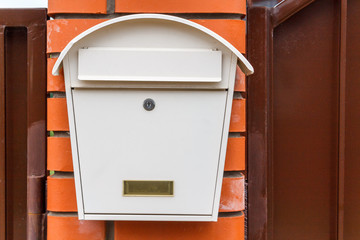A beautiful mailbox hangs waiting for newspapers, parcels and letters.